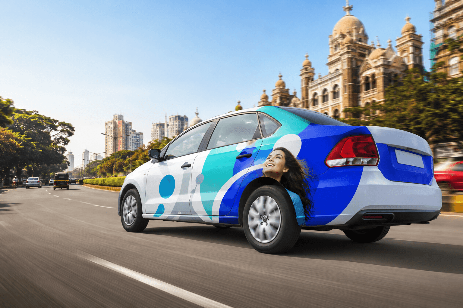 A branded vehicle sticker turning a car on a city street into a mobile billboard.